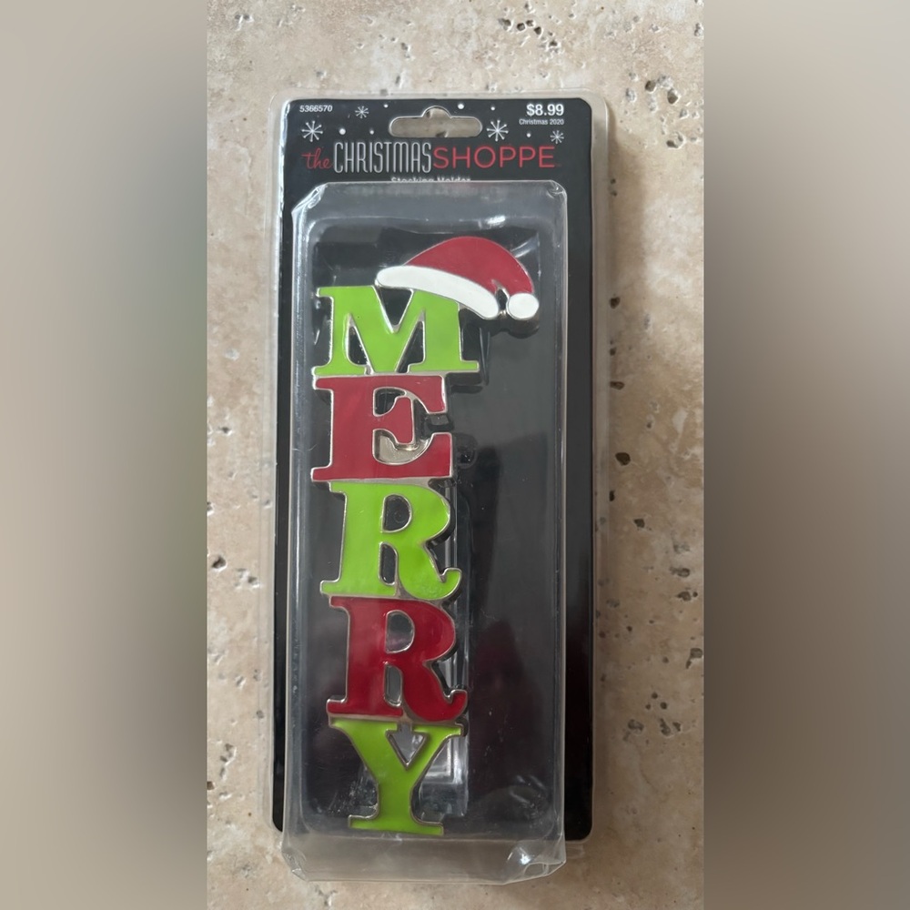 The Christmas Shoppe “Merry” stocking holder. New in package.